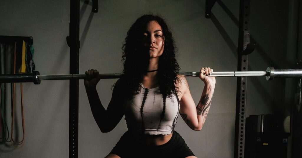 Woman feeling low energy during workout showing how hormonal changes after 30 can affect metabolism, strength, and fitness performance